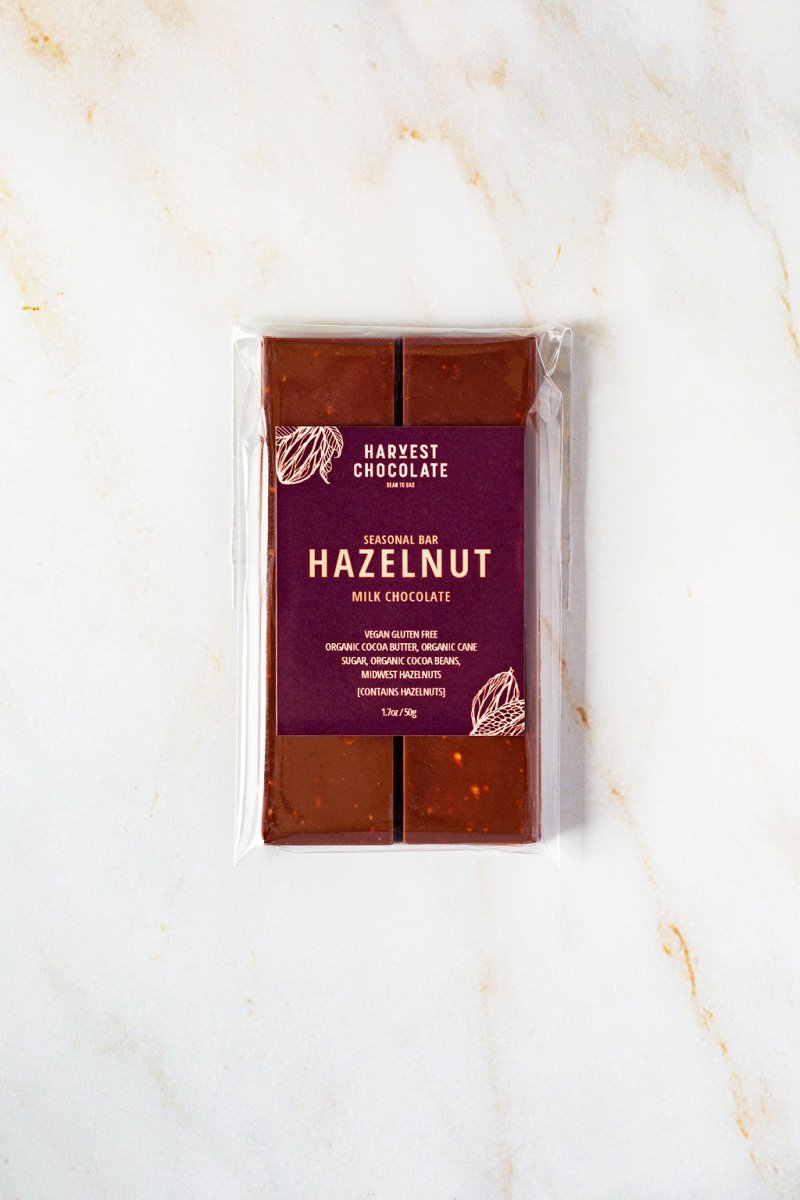 Harvest Chocolate Hazelnut Milk Chocolate Bar displayed on a white marble surface.