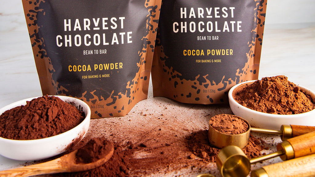 Harvest Chocolate cocoa powder packaging with cocoa powder on a white surface.