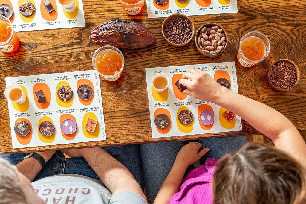 Guests tasting a flight of bean-to-bar chocolates around the table at Harvest Chocolate in Tecumseh, Michigan